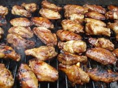 chicken wings are cooking on the grill