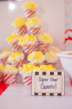 a table topped with cupcakes covered in frosting