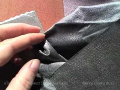 a person is opening up a piece of fabric to show how it's folded