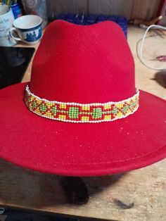 Great beadwork on this awesome beaded hatband, completely handmade with care. 22 inches long adjustable to fit almost any hat. Free shipping in USA Adjustable Beaded Fedora Hat Band, Handmade Artisan Adjustable Hat Bands, Artisan Beaded Adjustable Hats, Handmade Flat Brim Hat Bands For Festival, Handmade Adjustable Hat Band For Festivals, Artisan Hats With Beaded Short Brim, Handmade Fedora Hat Bands For Festivals, Handmade Artisan Hat Bands As Gift, Bohemian Beaded Brimmed Hat Bands