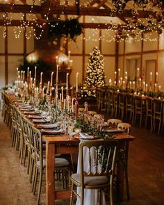 a long table is set with candles and place settings