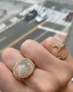 Instantly elevate your look with this stately 14k gold ring featuring a stunning opal centerpiece and brilliant diamond accents. 14k gold opal and diamond Opal: 8.9 tcw Diamond: 0.39 tcw Spot clean Handmade in NYC | Eden Presley Celeste Cocktail Ring 8 | Diamonds/Gemstones/Yellow GoldOpal 14k Gold Celestial Opal Ring, Celestial 14k Gold Opal Ring, Celestial Yellow Gold Round Opal Ring, Luxury Round Opal Rings, Celestial Yellow Gold Opal Ring, Celestial Multi-stone Round Rings, Luxury 14k Gold Round Opal Ring, Celestial Style Opal Round Rings, Opal And Diamond Ring