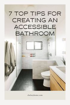 a bathroom with white tiles and black flooring is featured in the top tips for creating an accessible bathroom