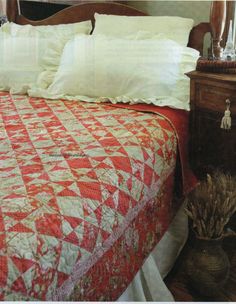 a red and white quilt on a bed