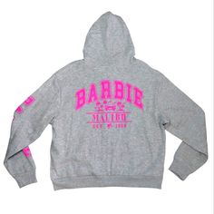 Officially Licensed Barbie Malibu Design On Front And Back. Barbie Logo On Arm. Zip Up Hoodie Sweatshirt. Ultra Soft Interior. Grey And Pink. 55% Cotton And 45% Polyester. Hh-3 Winter Pink Sweatshirt With Logo Print, Pink Long Sleeve Hoodie With Logo Print, Pink Logo Print Sweatshirt For Streetwear, Pink Winter Hoodie With Logo Print, Sporty Pink Sweatshirt With Logo Print, Winter Pink Hoodie With Logo Print, Casual Pink Hoodie With Logo Print, Pink Logo Print Athleisure Sweatshirt, Pink Logo Print Sweatshirt In Athleisure Style