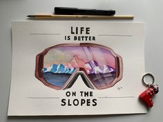 a piece of paper with an image of ski goggles on it and a keychain