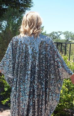 Check out our Silver Sequin Caftan Dress! Featuring large iridescent round sequins and Grey sheer, lightweight fabric. The oversized kimono-style sleeves add a touch of drama, while the one size fits all design ensures a comfortable and flattering fit for everyone. Don't miss out on this must-have addition to your wardrobe!MeasurementsWidth: 46" Length: 50-56" For care instructions, we recommend hand washing with cold water. The item will typically be created within 2-3 business days prior to sh Spring Party Kaftan With Sequins, Spring Party Kaftan With Kimono Sleeves, Blue Sequined Kaftan For Festive Occasions, Silk Sequined Party Kaftan, Blue Sequined Kaftan For Party, Festive Long Sleeve Sequined Kaftan, Festive Blue Sequined Kaftan, Blue Sequined Party Kaftan, Sequined Georgette Kaftan