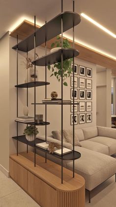 a living room filled with furniture next to a wall mounted shelf full of books and plants