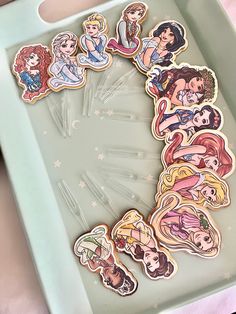 there are many princesses on the cookie sheet in this tray, and they look like stickers