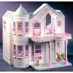 a doll house with pink furniture and accessories