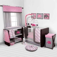 a baby's room with pink and gray decor, including a crib bedding set