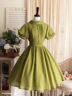 This price includes a dress and a green bowknot hairclip (not for sale).  Step into timeless elegance with our Olive Green Summer Chic Vintage Neckline Classic Lolita Dress. This enchanting piece captures the essence of classic Lolita fashion with a modern twist, making it a must-have for any Lolita wardrobe.  The dress features a rich olive green color that exudes sophistication and versatility, perfect for summer outings and garden parties. A beautifully crafted vintage neckline adds a touch o Vintage Green Dress 1950s Style, Vintage Style Dresses Classy, Vintage Dresses Aesthetic, Green Tea Dress, Vintage Dress Aesthetic, Simple Green Dress, Cute Vintage Dresses, Library Fashion, Dollcore Outfits