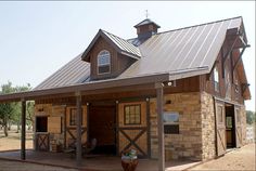 a horse barn with a covered porch and two stalls on the side of the building