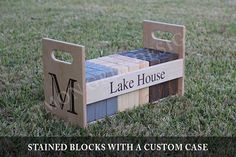 a small wooden bench made out of blocks with the name lake house written on it