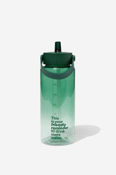 a green water bottle sitting on top of a white surface