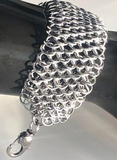 "DragonScale Woven Chainmaille Bracelet in Solid Stainless Steel. HANDWOVEN to a length of 6.5 Inches and is adjustable to fit most. This stunning, flowing metal's full dimensions are 1.25\" wide x 6.5\" long and finished with a solid Stainless Steel Lobster Clasp. There are over 550 rings in this item." Adjustable Chainmail Chain Bracelet, Adjustable Chainmail Chain Bracelet As A Gift, Chainmaille Bracelet, A Plus, Chain Link Bracelet, Link Bracelets, Chain Link, Lobster Clasp, Jewelry Bracelets