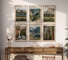 there are four pictures hanging on the wall above a table with two wicker chairs