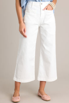 Transform your denim game with our Urban Oasis White Cropped Flare Jeans. These trendy jeans feature a cropped flare silhouette, perfect for showing off your favorite shoes. The clean white color adds a fresh touch to any outfit, making these a must-have for any fashionista's wardrobe. Level up your style game with these quirky and fun jeans! These white jeans feature a high waisted design, a button zipper closure, belt loops, functional front & back pockets, a cropped hemline, and a flared leg. White Wide Leg Cropped Cotton Jeans, Trendy White High-rise Flare Jeans, Chic White Wide Leg Cropped Jeans, Trendy White Mid-rise Flare Jeans, White Cotton Cropped Flare Jeans, White Cropped Jeans With Pockets, White Mid-rise Cotton Flare Jeans, White Denim Cropped Jeans With Pockets, White Mid-rise Flare Jeans In Cotton