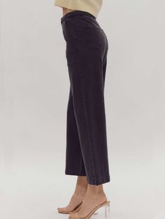 Elevate your style with our versatile and sophisticated high-waisted wide-leg pants. These solid black bottoms feature a unique braided detail at the waist, adding a touch of elegance to a timeless silhouette. The button and zipper closure ensures a secure fit, while the lightweight, woven fabric offers comfort and effortless movement. Designed for versatility, these pants are non-sheer and unlined, making them the perfect choice for both day and night. Pair with your favorite blouse or top for Fall High-waisted Wide Leg Pants For Elevated Casual, Washed Black Cropped Leg Bottoms For Fall, Chic High-waisted Pants For Elevated Casual Occasions, Chic Elevated Casual High-waisted Pants, Washed Black Cropped Leg Bottoms For Spring, Washed Black Bottoms With Belt Loops For Fall, Fall Washed Black Bottoms With Belt Loops, Washed Black Straight Leg Pants With Elastic Waistband, Washed Black Wide Leg Pants For Spring