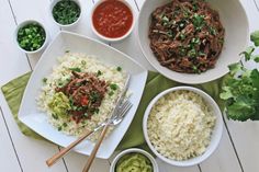 the meal is prepared and ready to be eaten on the table, including rice, beans, meat and vegetables