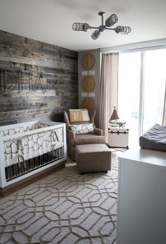 a baby's room with a crib, rocking chair and wooden wall behind it