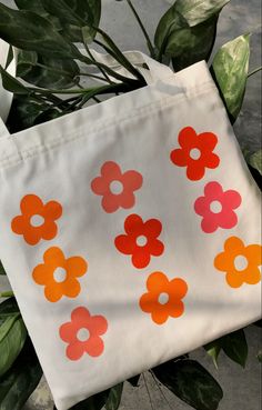 a white bag with orange and red flowers on it