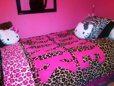 a hello kitty bedroom with pink walls and leopard print bedspread, black cat head on the pillow