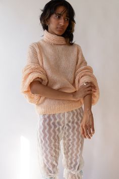 "Peach acrylic knit sweater from the 80s. Large dolman balloon sleeves. Open knit, semi-sheer. Soft acrylic knit.  Brand: Mary Ann McGaughey Material: Acrylic Condition: Excellent Fits: Small-Large Measurements: Chest - open / Hem width - 35-41\" / Length - 26\" Aayushi is a size 26 and 5'9" Balloon Sleeve Sweater, Chest Opening, Pullover Outfit, Mary Ann, Pullover Sweater Women, Semi Transparent, Open Knit, The 80s, Balloon Sleeves