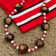 a red and white striped shirt is next to a necklace with chocolates on it