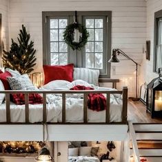 a bedroom with christmas decorations and lights on the windowsill, stairs leading up to it