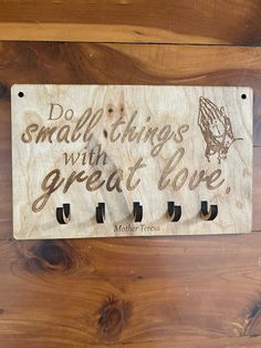 a wooden sign that says do small things with great love