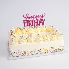 a birthday cake with white frosting and sprinkles