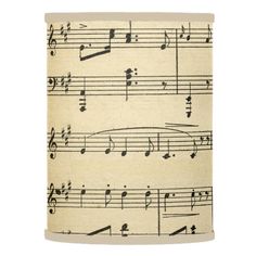 an old sheet with musical notes on it is hanging from a lamp shade that has been made out of fabric