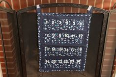 a fireplace with a quilt hanging on the back of it's sides and numbers