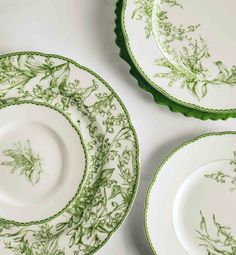 three green and white plates sitting next to each other