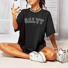 Comfort Colors Salty Summer T-Shirt, Comfort Colors Tee, Trendy Beach Shirt, Funny Shirt Women, Gift For Women, Vacation Shirt, Gift For Her 🌸Material: Crafted with 6.1 oz/yd² of premium 100% Ring Spun US cotton, ensuring superior quality and comfort. 🌸Fit: Features a relaxed fit that is both comfortable and stylish, suitable for all genders and sizes. 🌸Collar: Equipped with a topstitched, classic width, rib collar for a timeless and refined look. 🌸Sizing: Runs true to size, providing a cons Black Short Sleeve Top For Beach Season, Black Letter Print T-shirt For Beach Season, Black Text Print Top For Vacation, Black Text Print Tops For Vacation, Casual Crew Neck Top For Beach Season, Black Crew Neck Top For Beach Season, Casual Beach Season Tops For Streetwear, Casual Beach Season Streetwear Tops, Casual Streetwear Tops For Beach Season