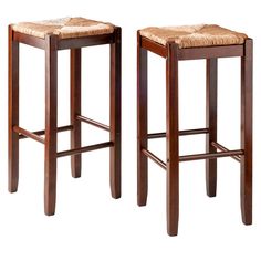 two wooden stools side by side on a white background and one has a brown leather seat