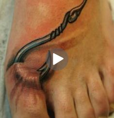 a person with a tattoo on their foot that has a snake crawling out of it