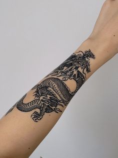 a person with a dragon tattoo on their arm