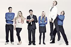 a group of people standing next to each other in front of a white background with their arms crossed