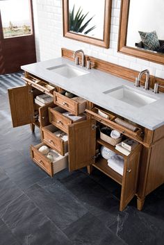 a double sink vanity with drawers underneath it