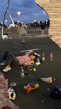 a man laying on the ground with his head down next to an airplane and other items