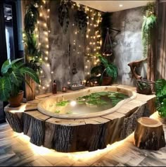 an indoor hot tub surrounded by potted plants and lights on the wall behind it