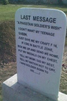 a memorial stone with the words last message written on it in front of a grassy area