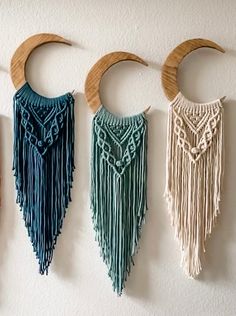 three macrame wall hangings with crescent moon on the top and one in the middle