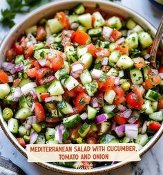 a bowl filled with cucumber, tomato and onion salad