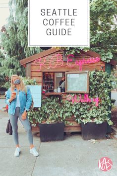 a woman standing in front of a building with the words seattle coffee guide on it