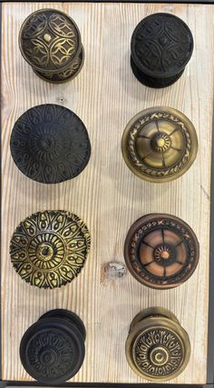 an assortment of door knobs on a wooden surface