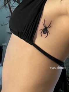 a woman with a spider tattoo on her stomach