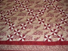 a red and white quilt is laying on the floor